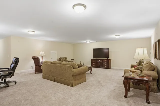 a living room with furniture a flat screen tv and a couch