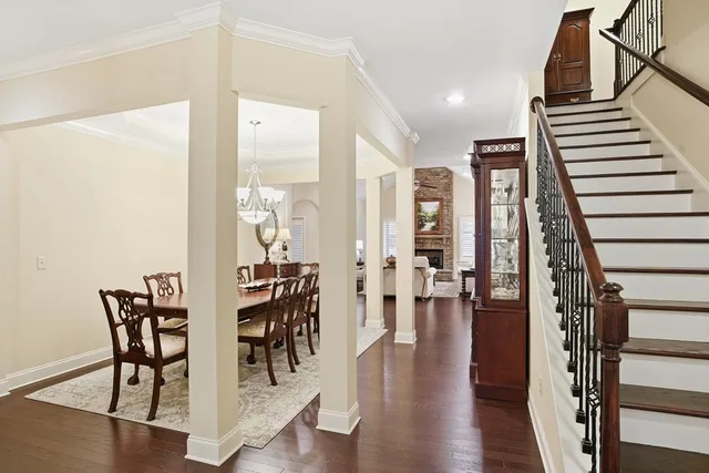a view of a a dining room with furniture window and wooden floor