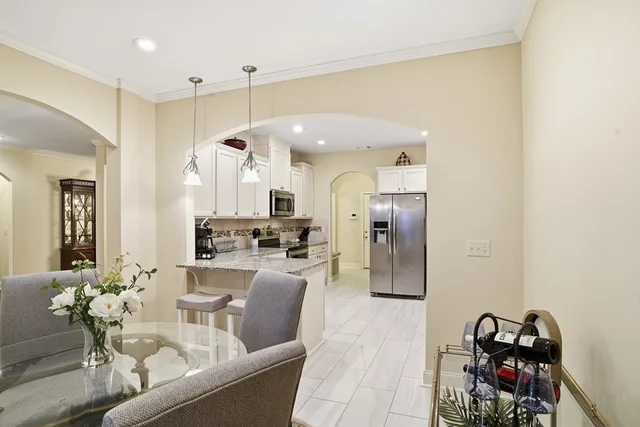 a living room with furniture a dining table and chairs
