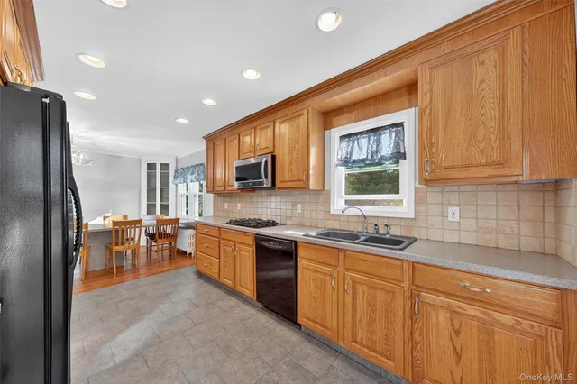 a kitchen with lots of counter top space sink and stainless steel appliances