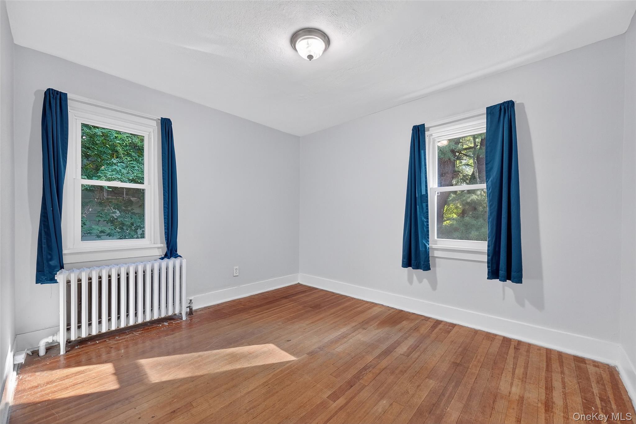 34 Mountainview Road Poughkeepsie, NY 12603 - Photo 16 of 28 an empty room with wooden floor and windows