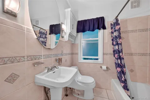 a view of a porch with wooden floor and fence