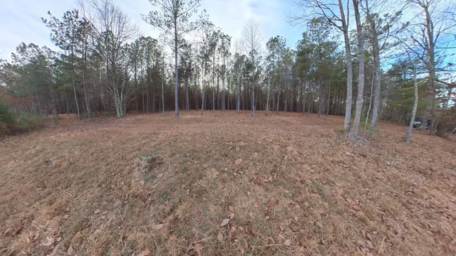 a view of a dirt road with a building in the background