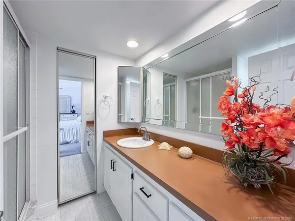 a spacious bathroom with a granite countertop sink