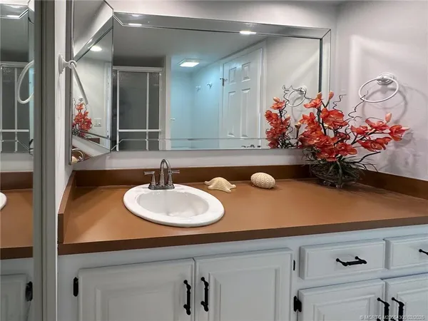 a bathroom with a sink a vanity and a mirror