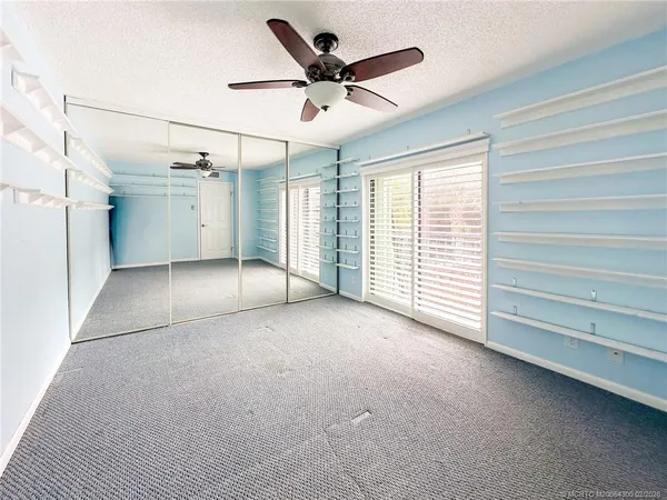 a view of a livingroom with a ceiling fan and window