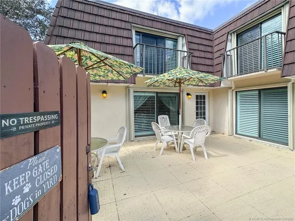 a view of a chair and table in the patio