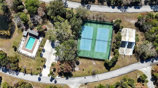 an aerial view of a house with a yard