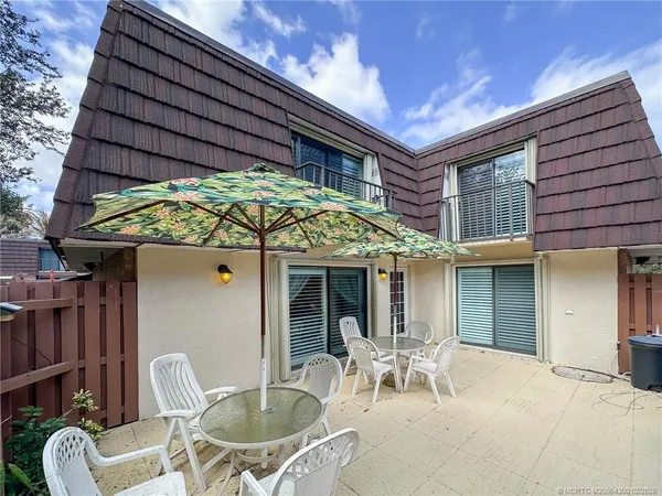 a patio with a table and chairs