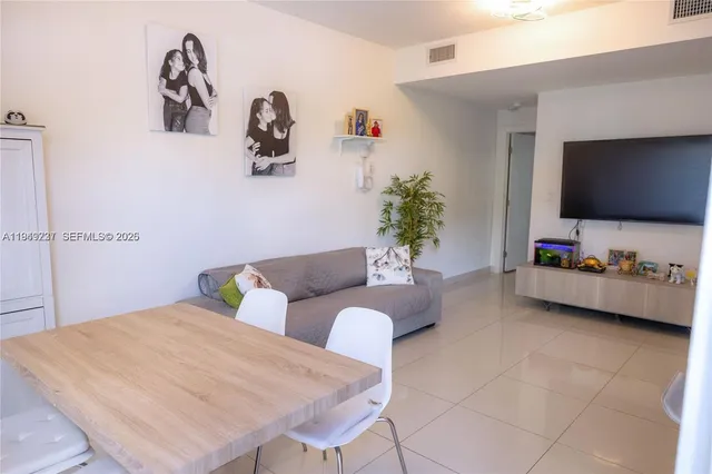 a bedroom with furniture and a flat screen tv