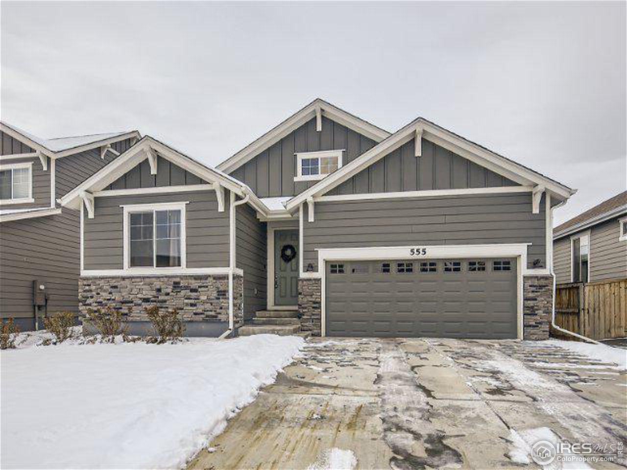 555 Ranchhand Drive Berthoud, CO 80513 - Photo 2 of 11 a front view of a house with a yard and garage