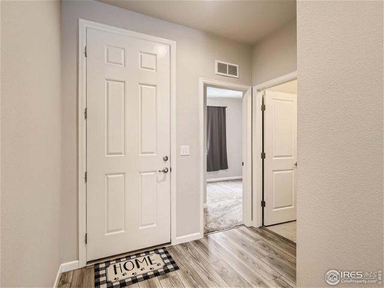 555 Ranchhand Drive Berthoud, CO 80513 - Photo 3 of 11 a view of a hallway with wooden floor and closet area