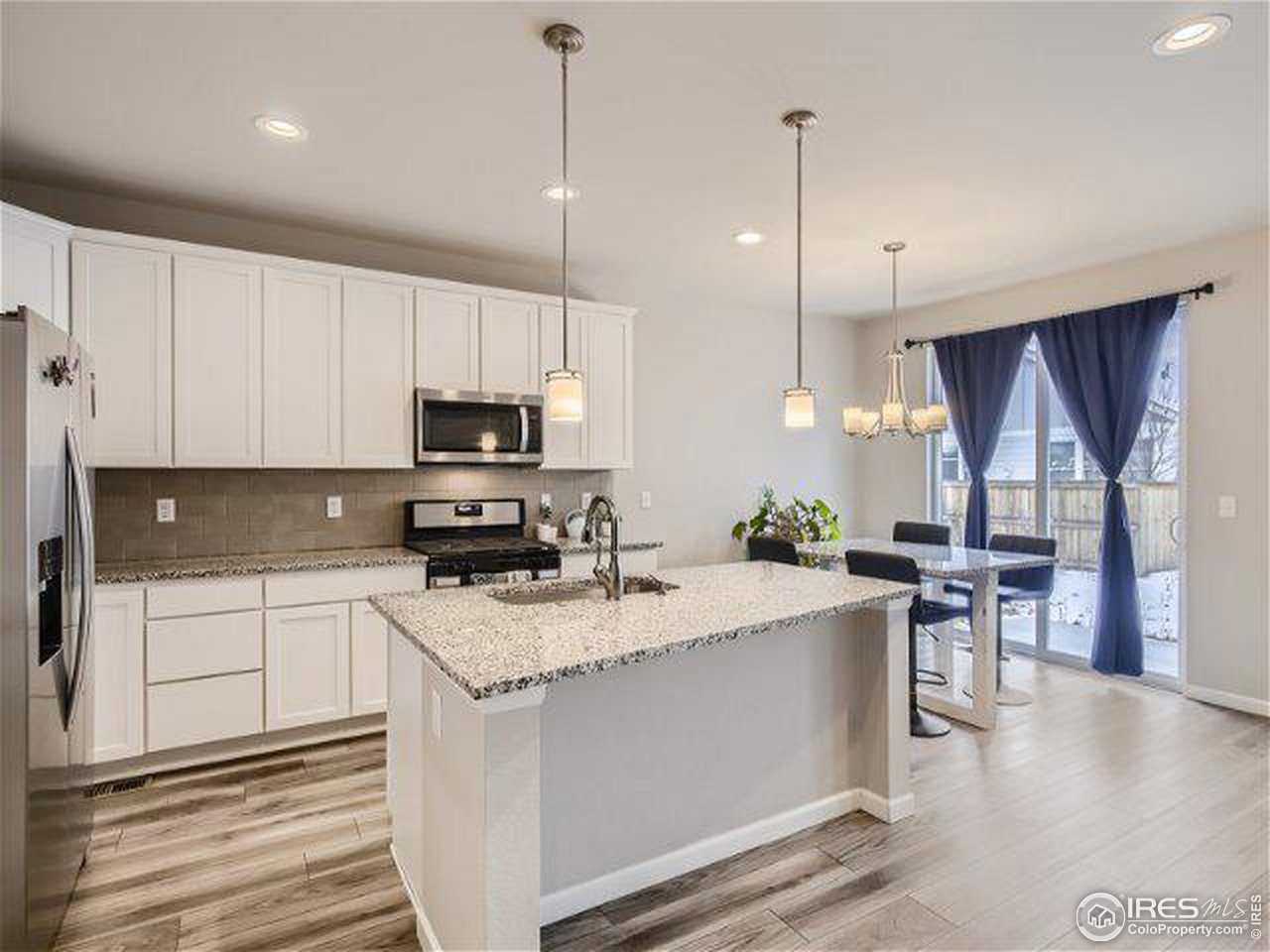 555 Ranchhand Drive Berthoud, CO 80513 - Photo 5 of 11 a kitchen with a sink a counter top space appliances and cabinets
