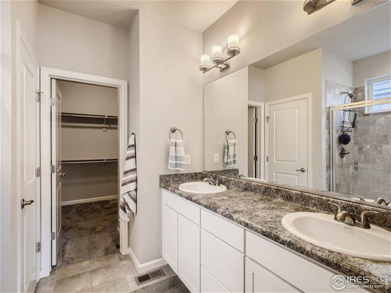 555 Ranchhand Drive Berthoud, CO 80513 - Photo 8 of 11 a bathroom with a granite countertop sink and a mirror