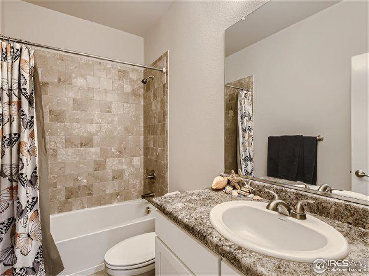 555 Ranchhand Drive Berthoud, CO 80513 - Photo 9 of 11 a bathroom with a granite countertop sink toilet and shower