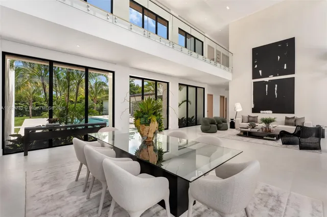 a view of living room kitchen with stainless steel appliances granite countertop couches and a large window