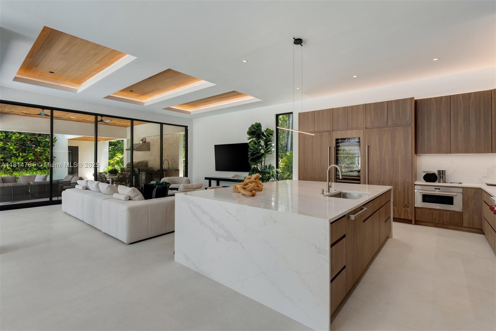 6730 Southwest 115th Street Pinecrest, FL 33156 - Photo 17 of 77 a view of living room kitchen with stainless steel appliances granite countertop couches and a large window