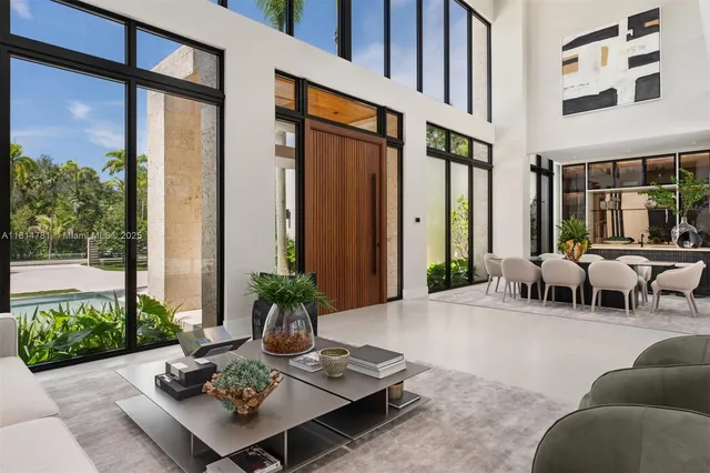 a living room with furniture a flat screen tv and kitchen view
