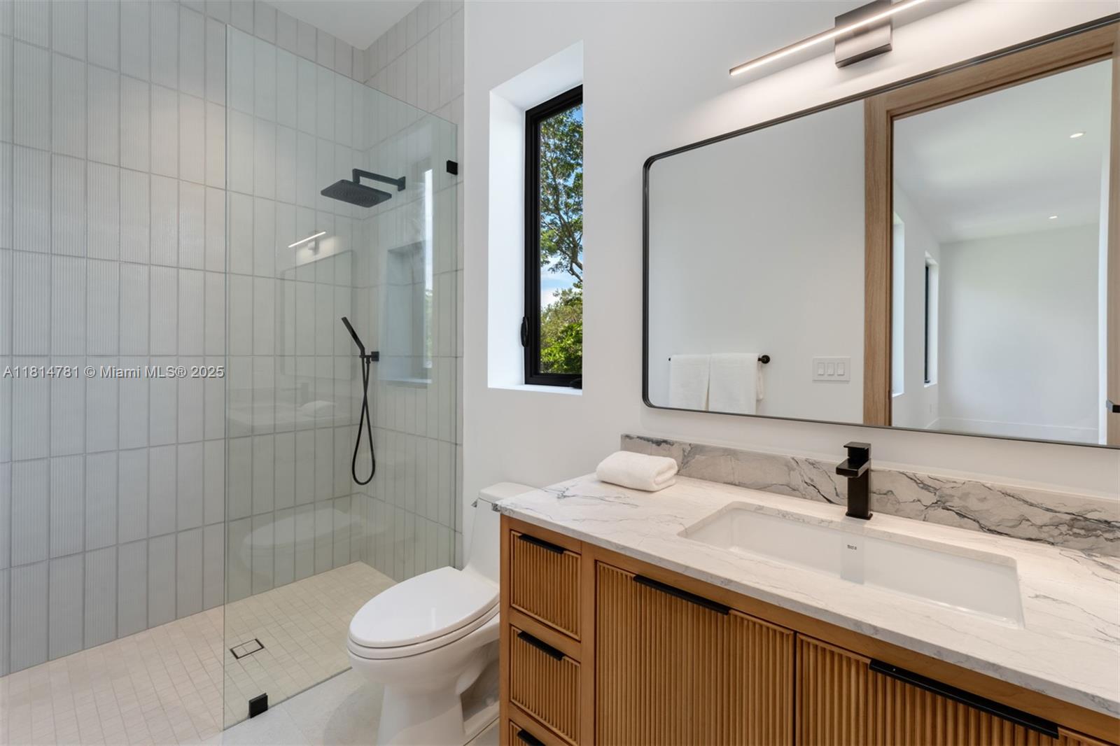 6730 Southwest 115th Street Pinecrest, FL 33156 - Photo 25 of 77 a bathroom with a granite countertop sink toilet and shower