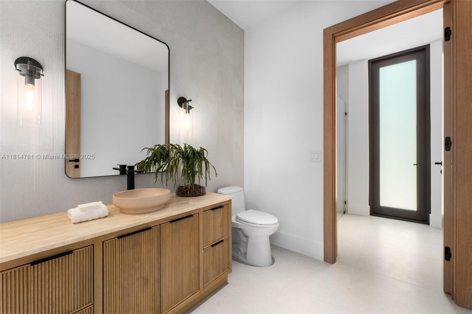6730 Southwest 115th Street Pinecrest, FL 33156 - Photo 26 of 77 a bathroom with a granite countertop sink and a mirror