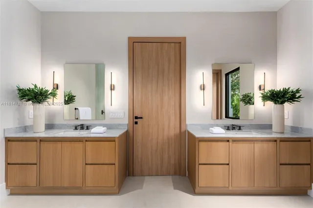 a bathroom with a granite countertop sink a mirror and cabinets