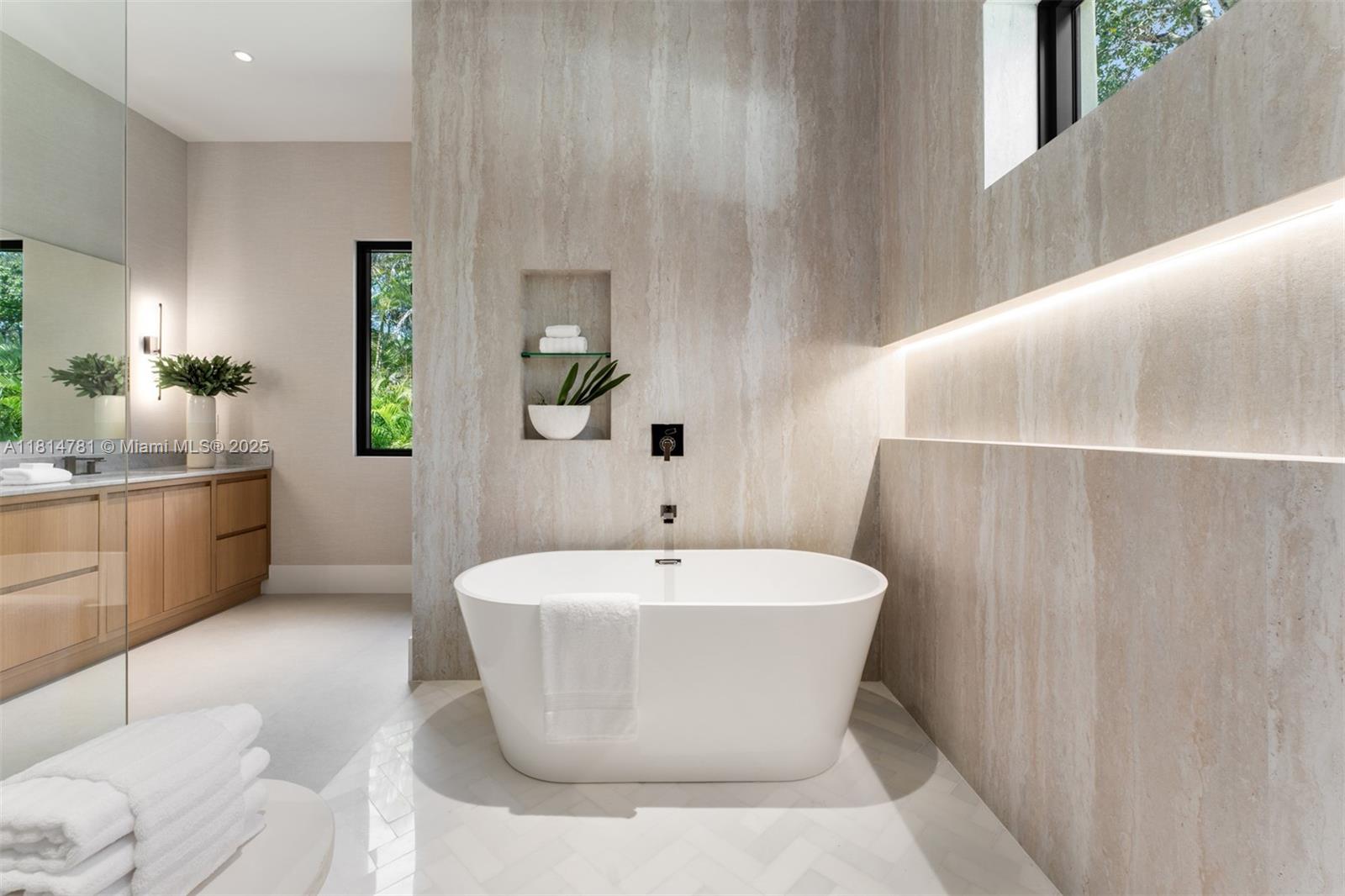 6730 Southwest 115th Street Pinecrest, FL 33156 - Photo 30 of 77 a white bath tub sitting in a bathroom