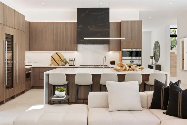 a living room with furniture and floor to ceiling windows