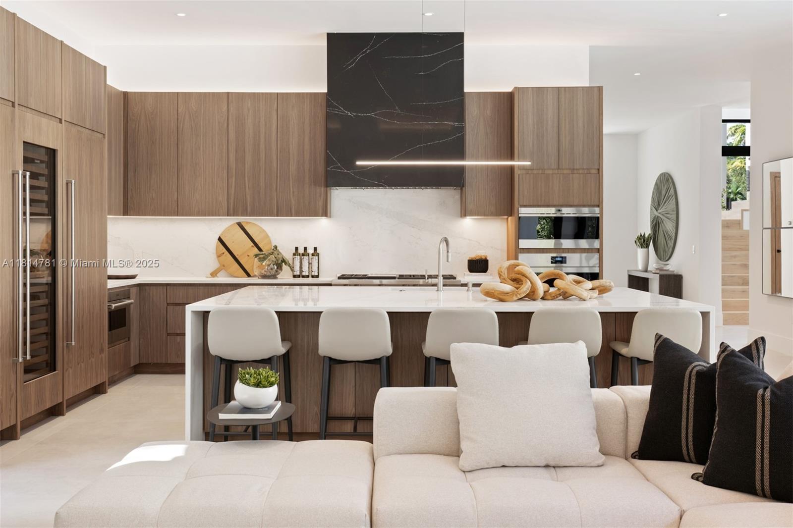 6730 Southwest 115th Street Pinecrest, FL 33156 - Photo 3 of 77 a living room with furniture a flat screen tv and kitchen view