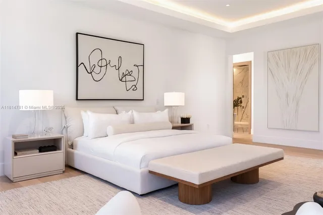 a bedroom with a bed and a potted plant