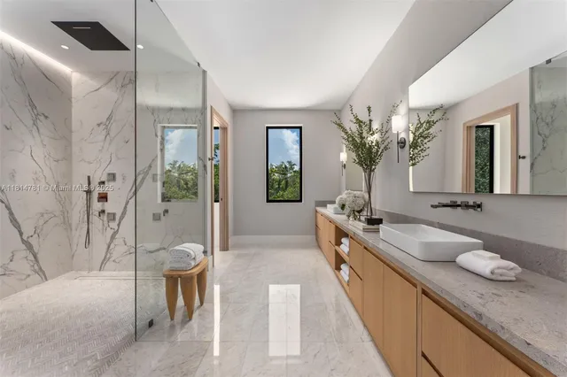 a bathroom with a granite countertop sink a toilet and shower