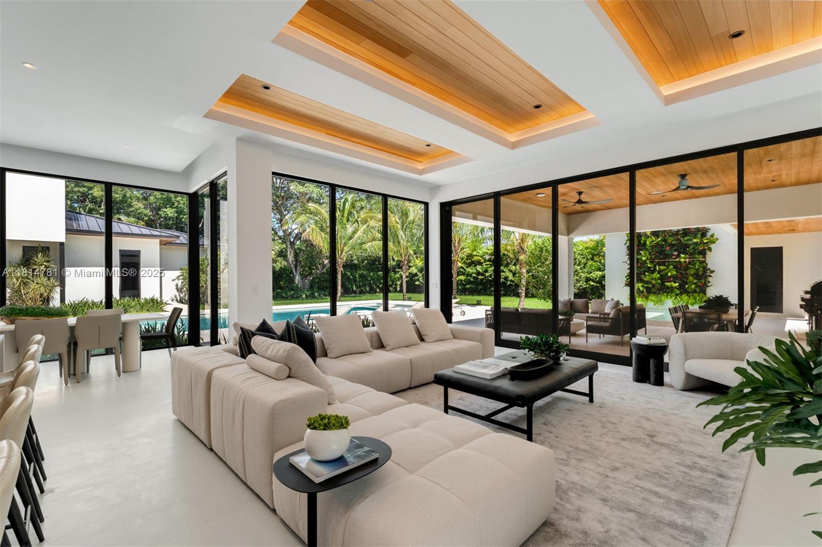 6730 Southwest 115th Street Pinecrest, FL 33156 - Photo 4 of 77 a living room with furniture and floor to ceiling windows