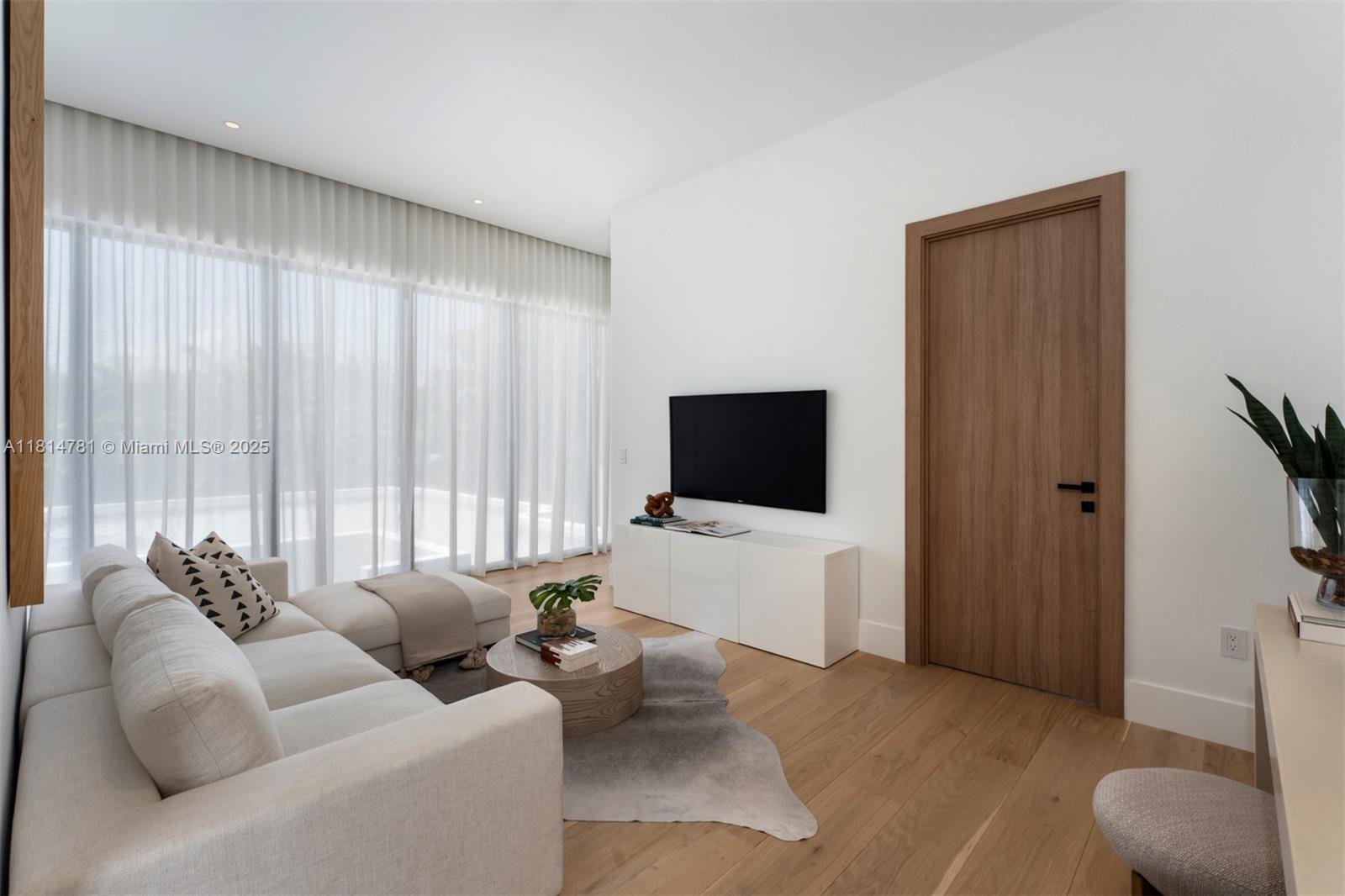 6730 Southwest 115th Street Pinecrest, FL 33156 - Photo 43 of 77 a living room with furniture and a flat screen tv