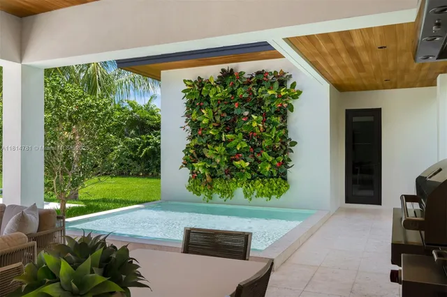 a view of a house with swimming pool and sitting area