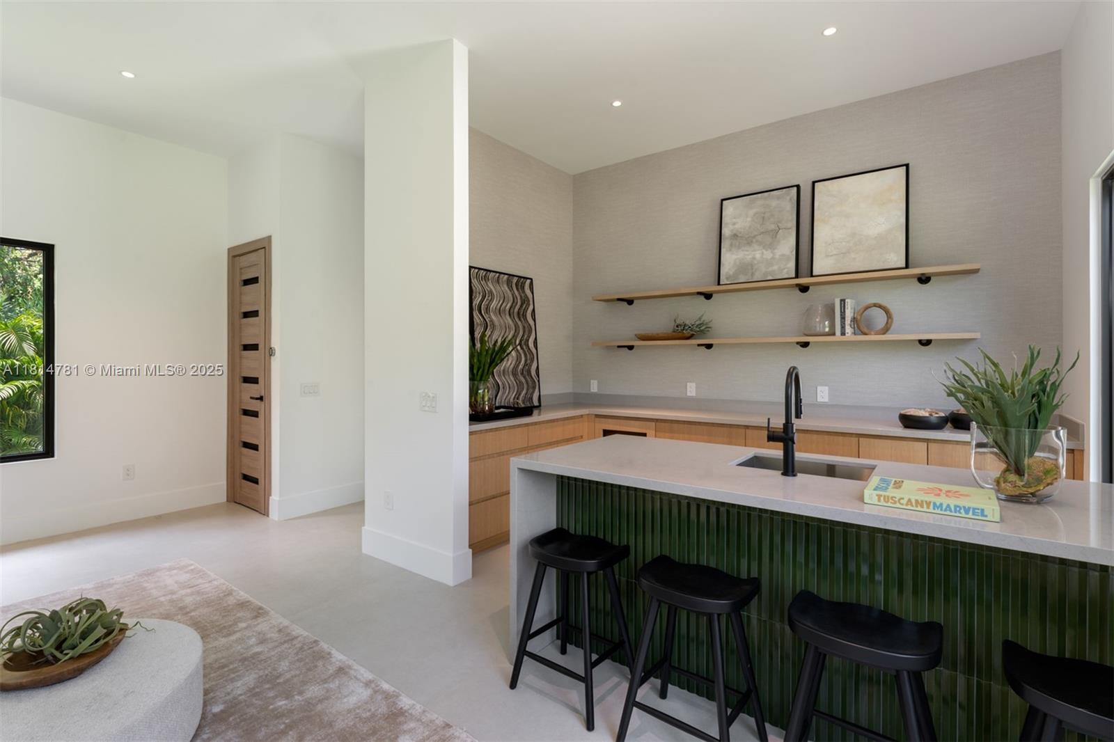 6730 Southwest 115th Street Pinecrest, FL 33156 - Photo 54 of 77 a kitchen with a table chairs refrigerator and cabinets