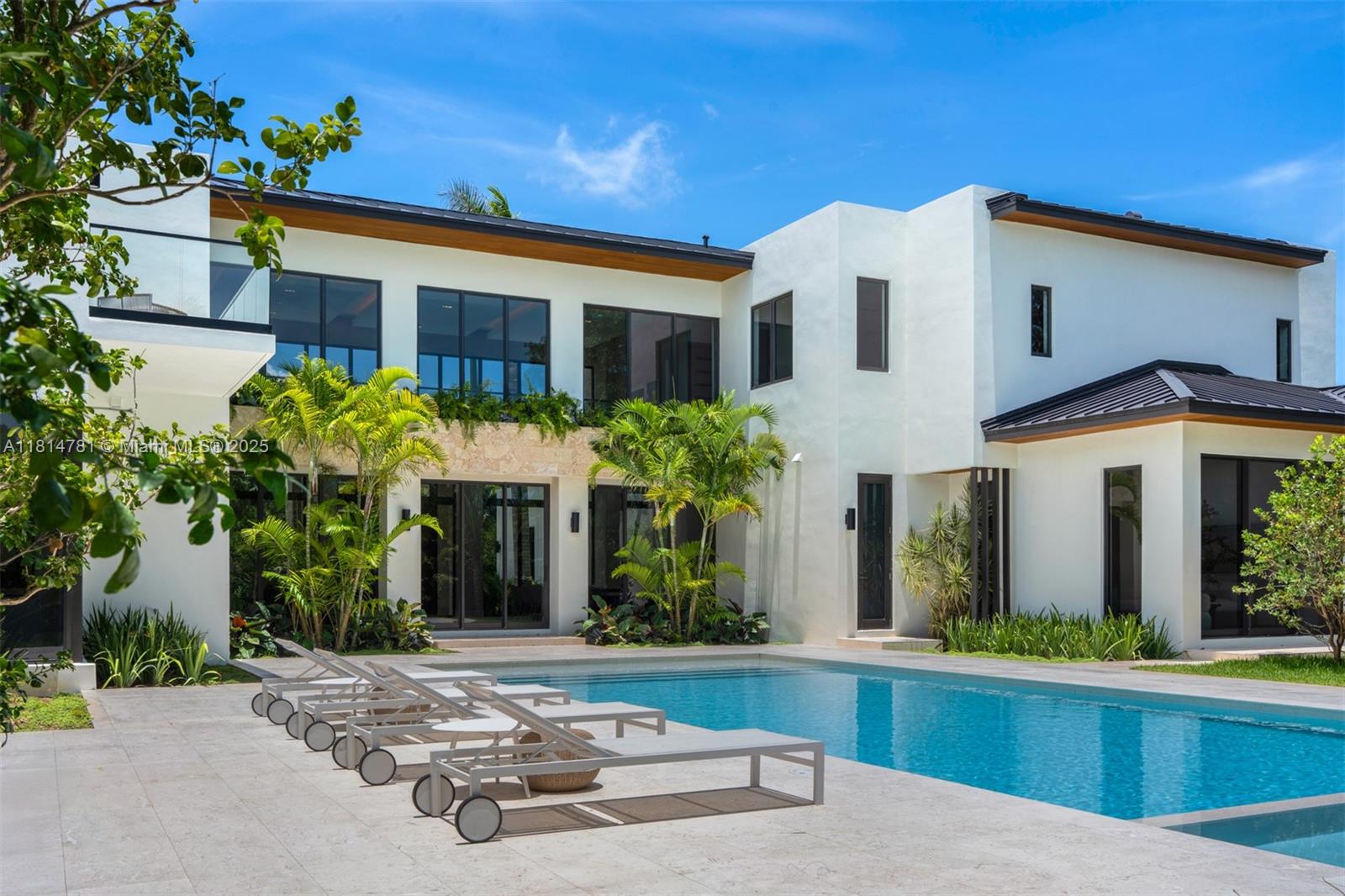 6730 Southwest 115th Street Pinecrest, FL 33156 - Photo 57 of 77 a front view of a house with garden
