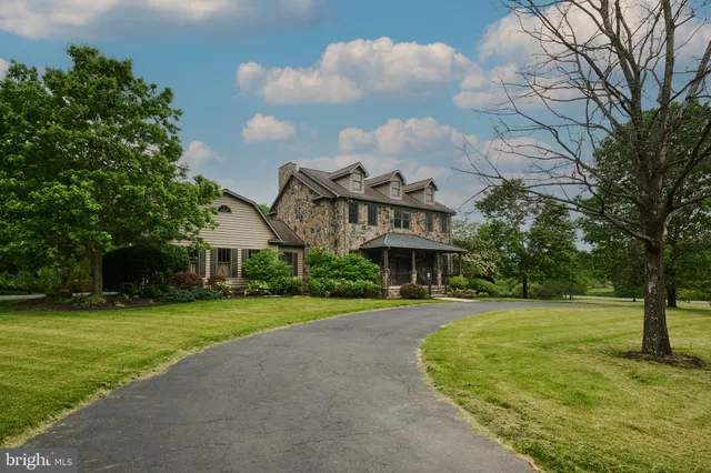 a view of a livingroom with a fireplace and a window