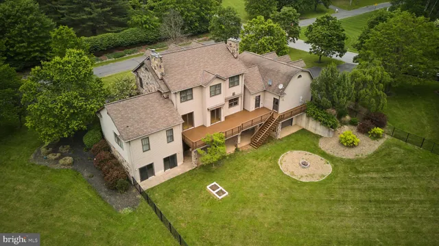 an aerial view of a house with a yard and balcony