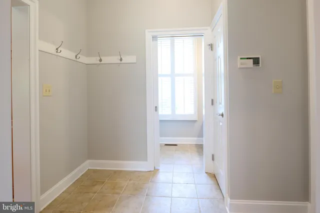 a bathroom with a double vanity sink mirror and bathtub