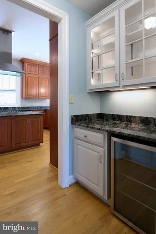 a view of staircase with railing and a chandelier