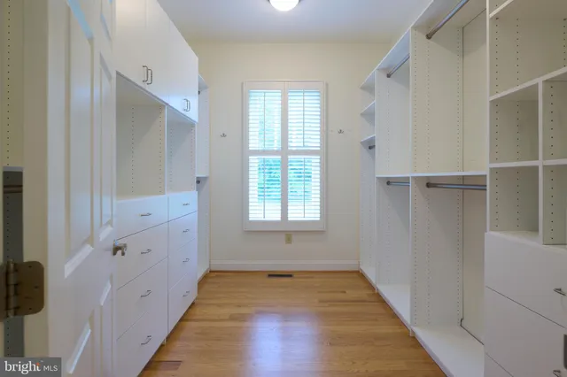 a view of balcony with wooden floor and fence and a potted plant