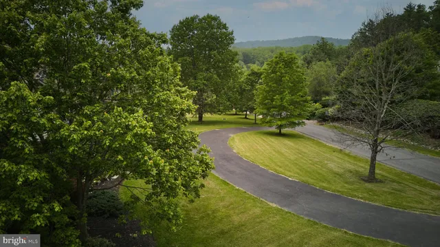 an aerial view of a house with garden space and street view