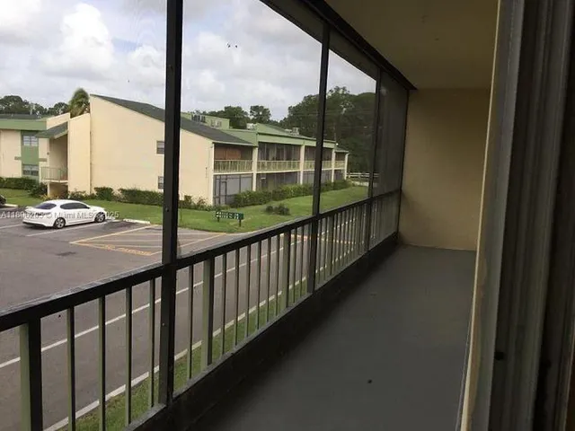 a view of balcony with mountain view and wooden floor