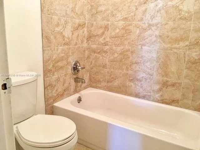 a bathroom with a bathtub and toilet