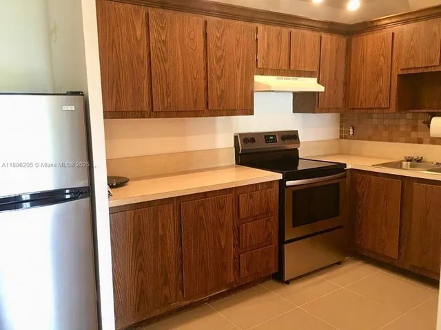 a kitchen with a stove a sink and a microwave