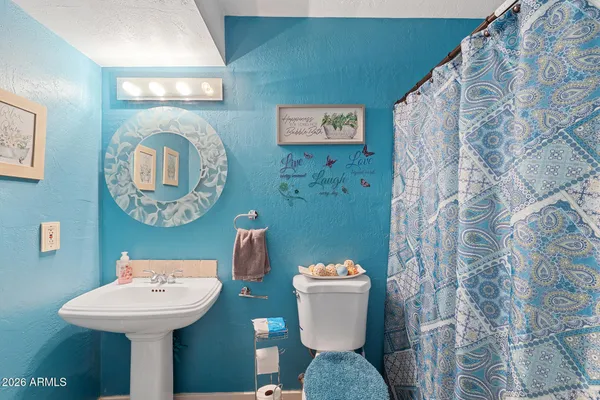 a bathroom with a toilet sink and mirror
