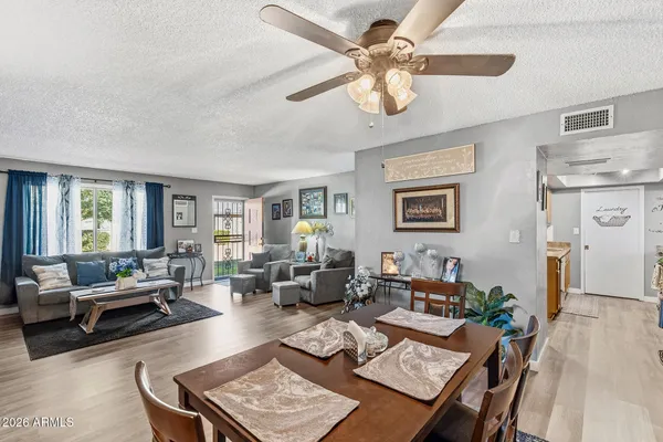 a living room with furniture and a wooden floor