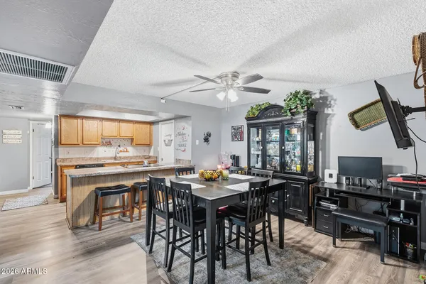 a room with stainless steel appliances kitchen island granite countertop furniture and a dining table