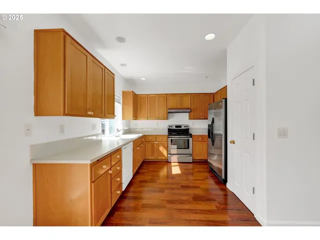 a kitchen with granite countertop cabinets stainless steel appliances and a sink
