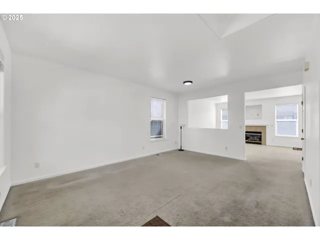 a living room with furniture fireplace and window