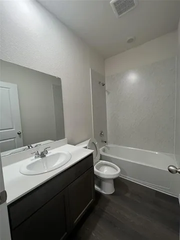 a bathroom with a double vanity sink toilet and a bathtub